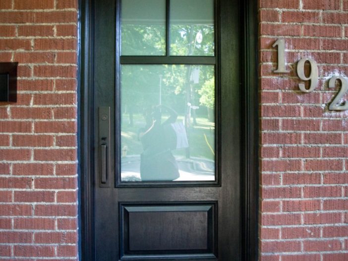 painted black woodgrain fiberglass entry door