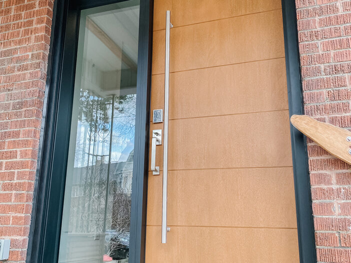 Smooth fiberglass front door with mahogany grain finish installed in a Toronto home