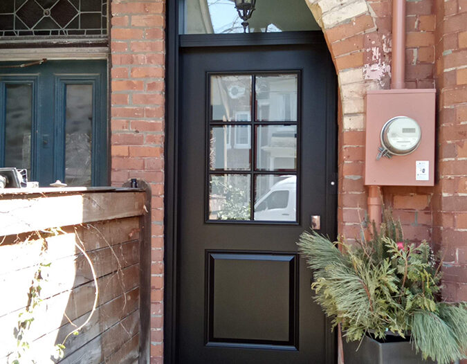 Smooth fiberglass front door with a transom installed in a Toronto home