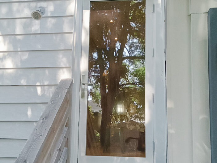 White rail-and-stile front door installed in a Toronto home