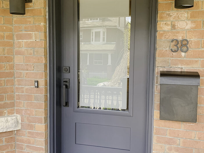 Marine Dusk shake-style door with frosted glass accents installed in a Toronto home