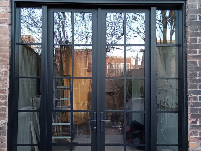 Black fiberglass rail-and-stile double doors installed in a Toronto home