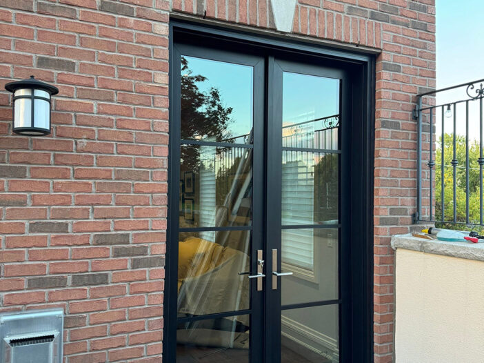 Side angle of a black rail and stile door, highlighting its sturdy frame and sleek finish