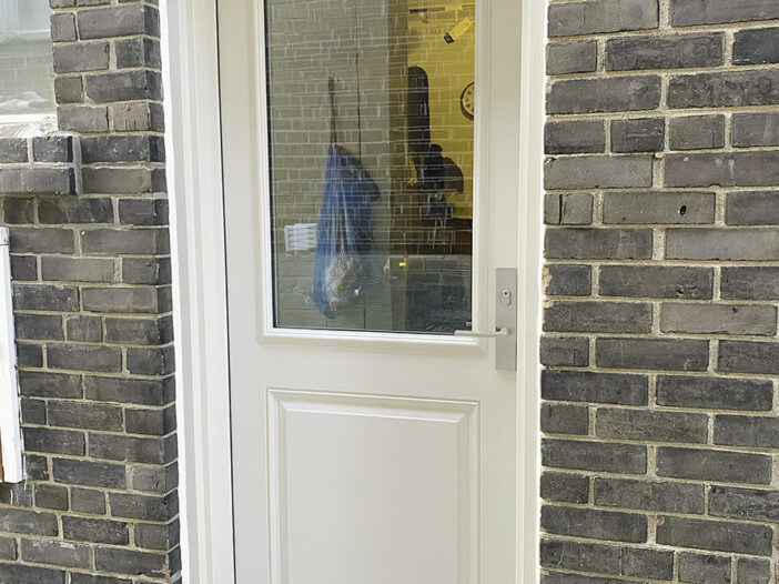Elegant 2-panel cashmere fiberglass door installed as a side entrance, enhancing the curb appeal of a Toronto home.