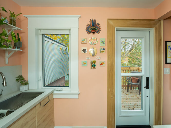 White vinyl kitchen window with a clean, modern design, allowing natural light to brighten the space.