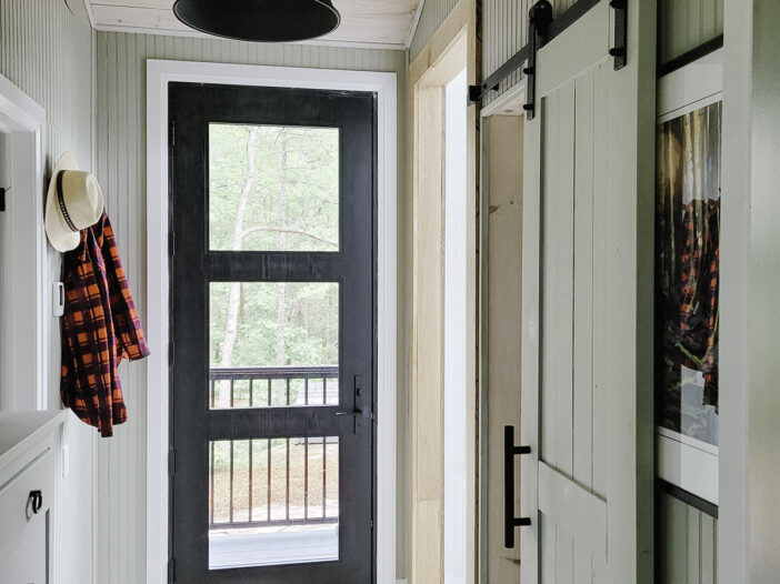 Black oak grain fiberglass entry door installed inside a Muskoka cottage.