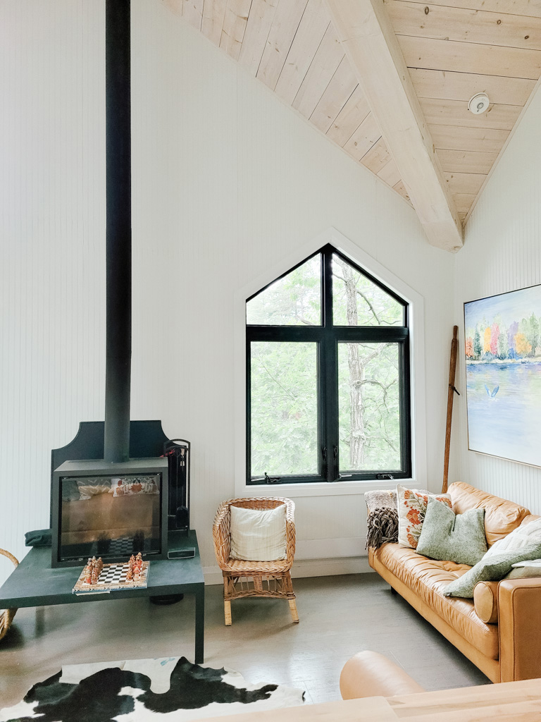 Interior view of Muskoka cottage living room with black casement windows and custom direct set windows above.