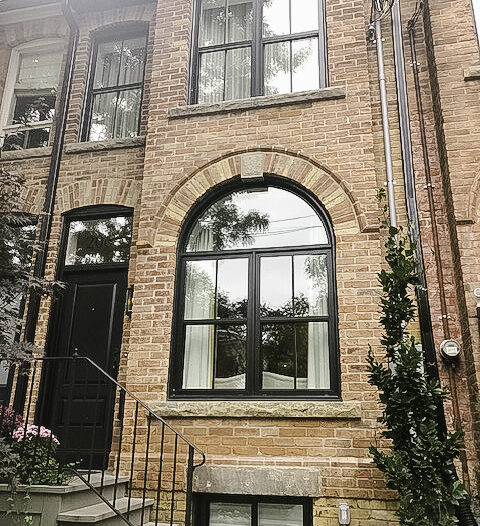 Black vinyl hung windows with SDL grilles installed on a classic brick Toronto home in collaboration with designer Joel Bray.