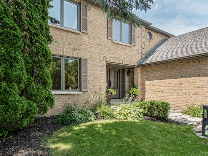 Side angle of Aurora home with Sable vinyl casement windows
