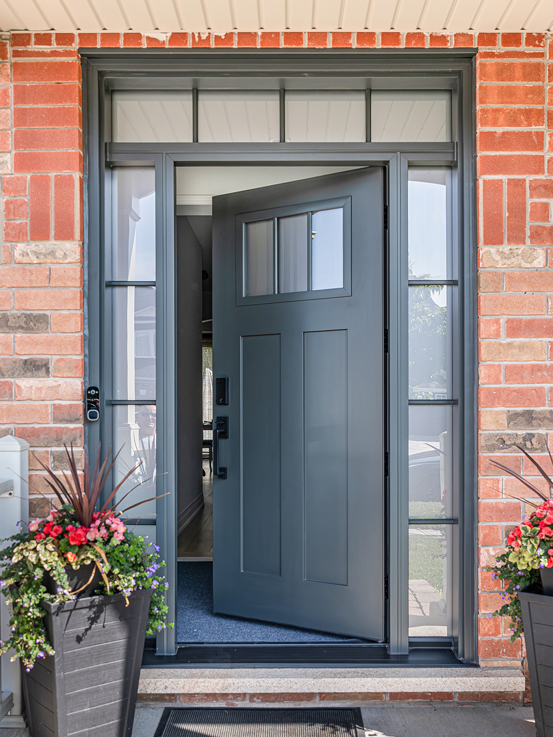 Craftsman front door with sidelights and transom on a Stouffville home.