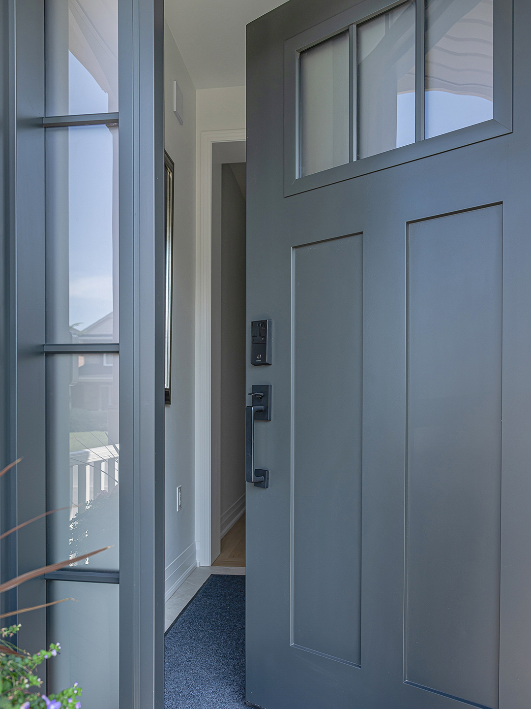 A detailed view of the craftsman-style window detailing, featuring textured glass framed with precision woodwork.