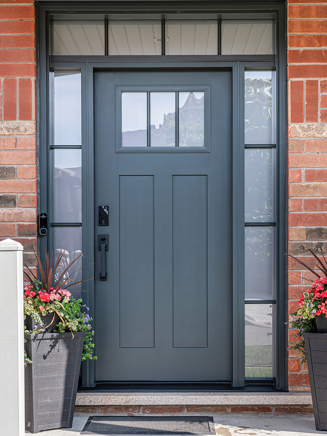 A front-facing view of the fully installed Craftsman door in natural lighting, highlighting its detailed woodgrain finish and impeccable craftsmanship.