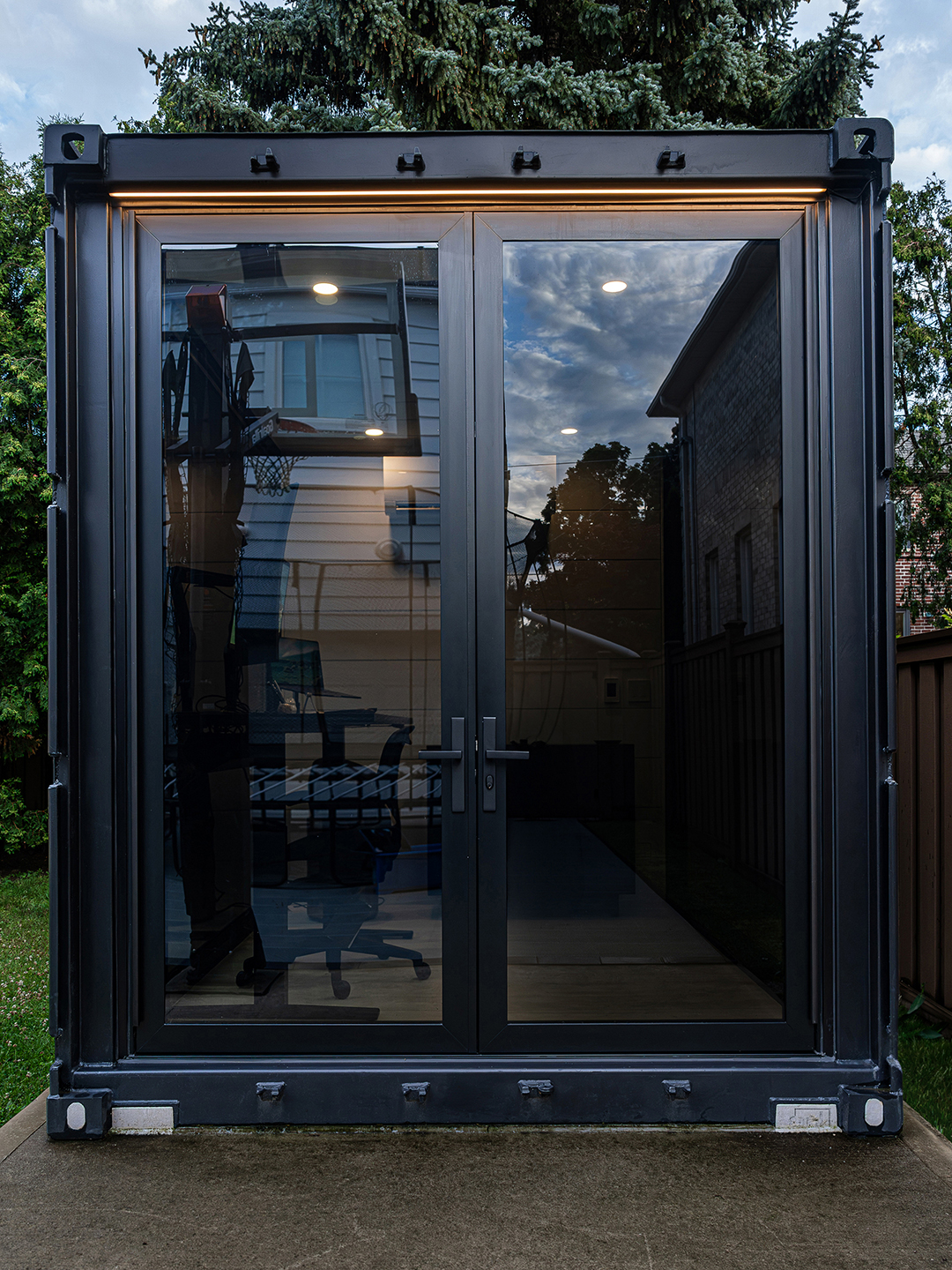 Exterior view of the container office with the modern rail and stile door closed.