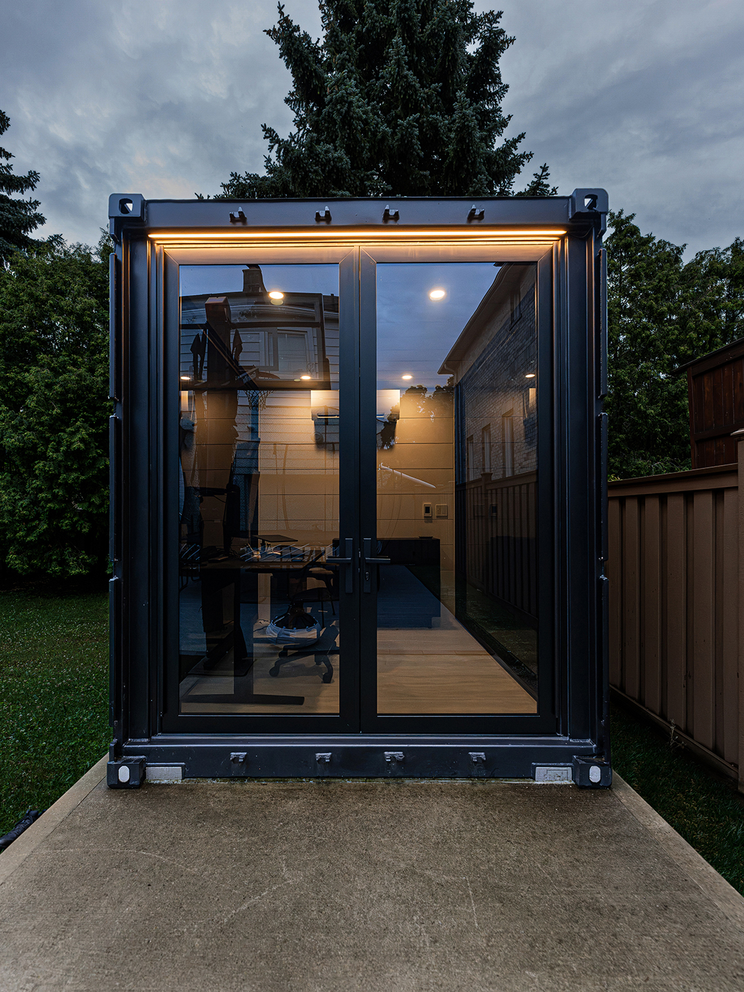 Exterior view of the container office with large windows and clean architectural lines.