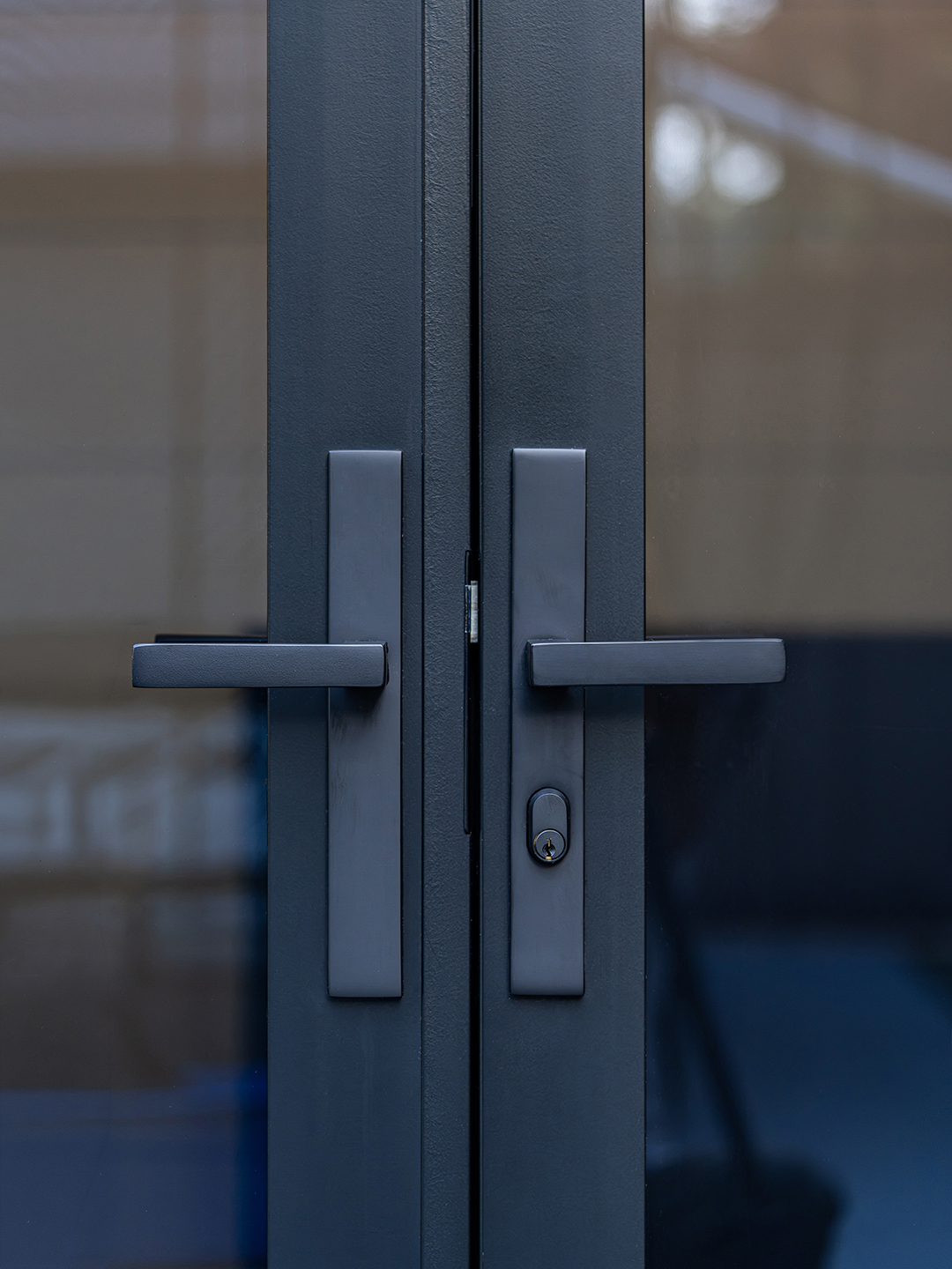 Close-up of the rail and stile door hardware on the container office.