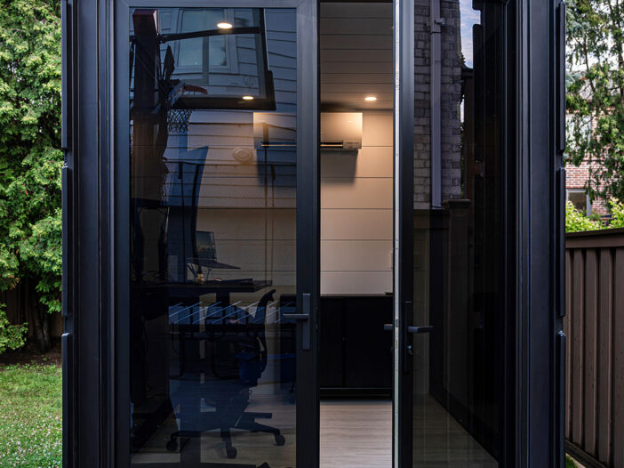 Exterior view of the container office with the modern rail and stile door open.