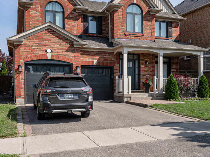 Front exterior of Stouffville home with new vinyl casement windows in an iron ore finish