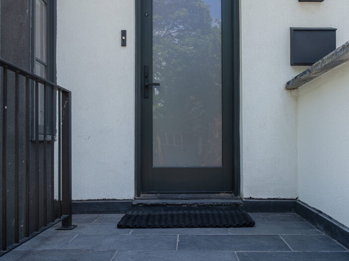 Toronto fiberglass entry door with Iron Ore colour finish and black hardware