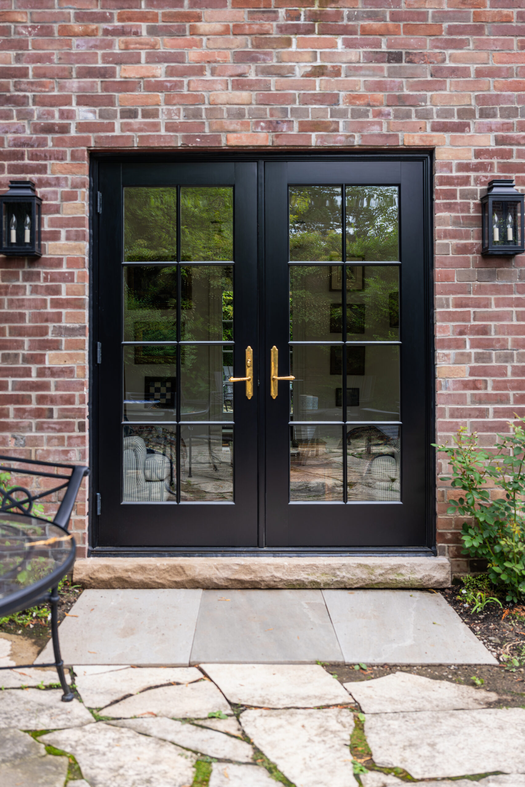 Exterior view of wood French hinged doors on garden studio in Toronto.