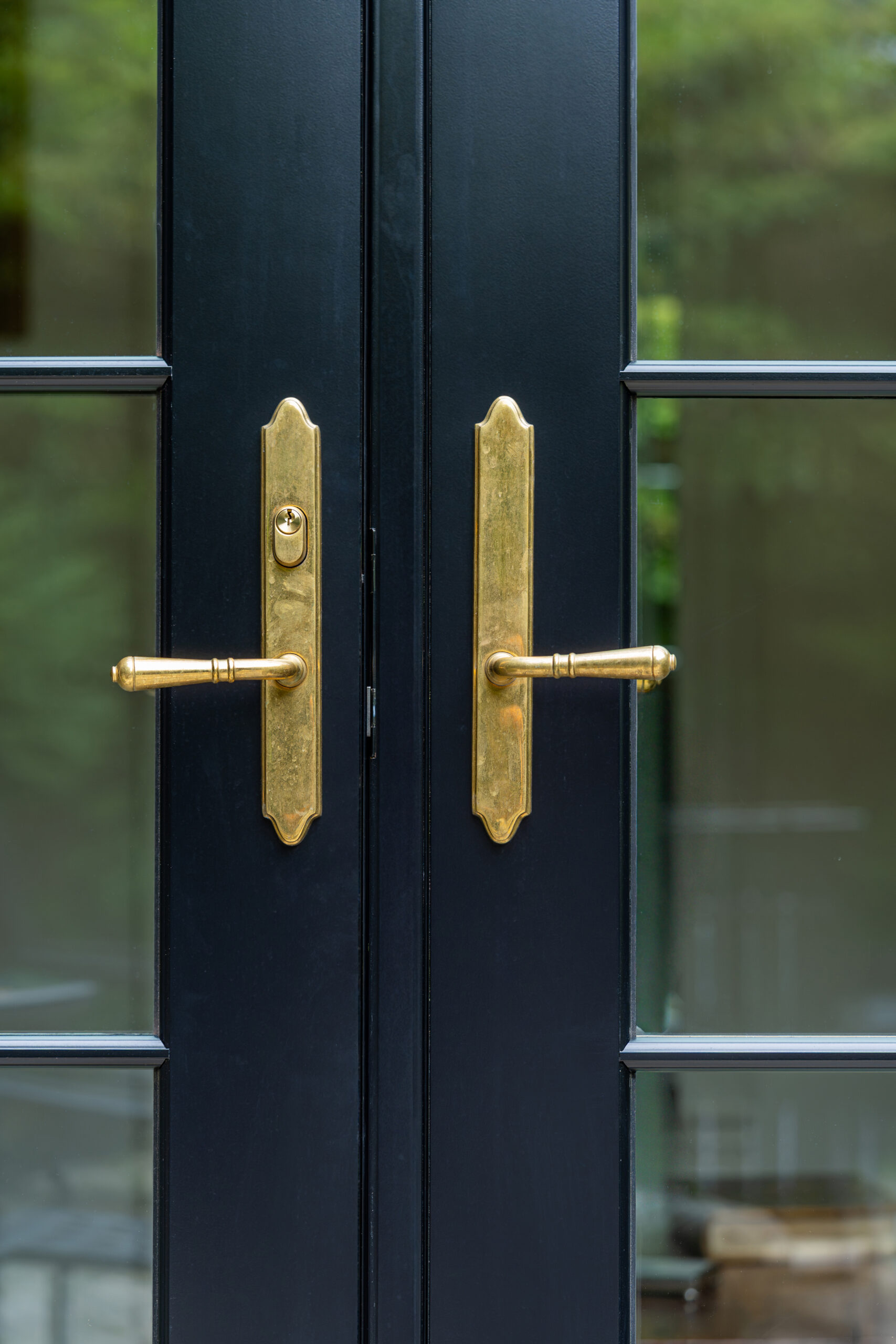 Close-up of hardware on Red Grandis wood French door.