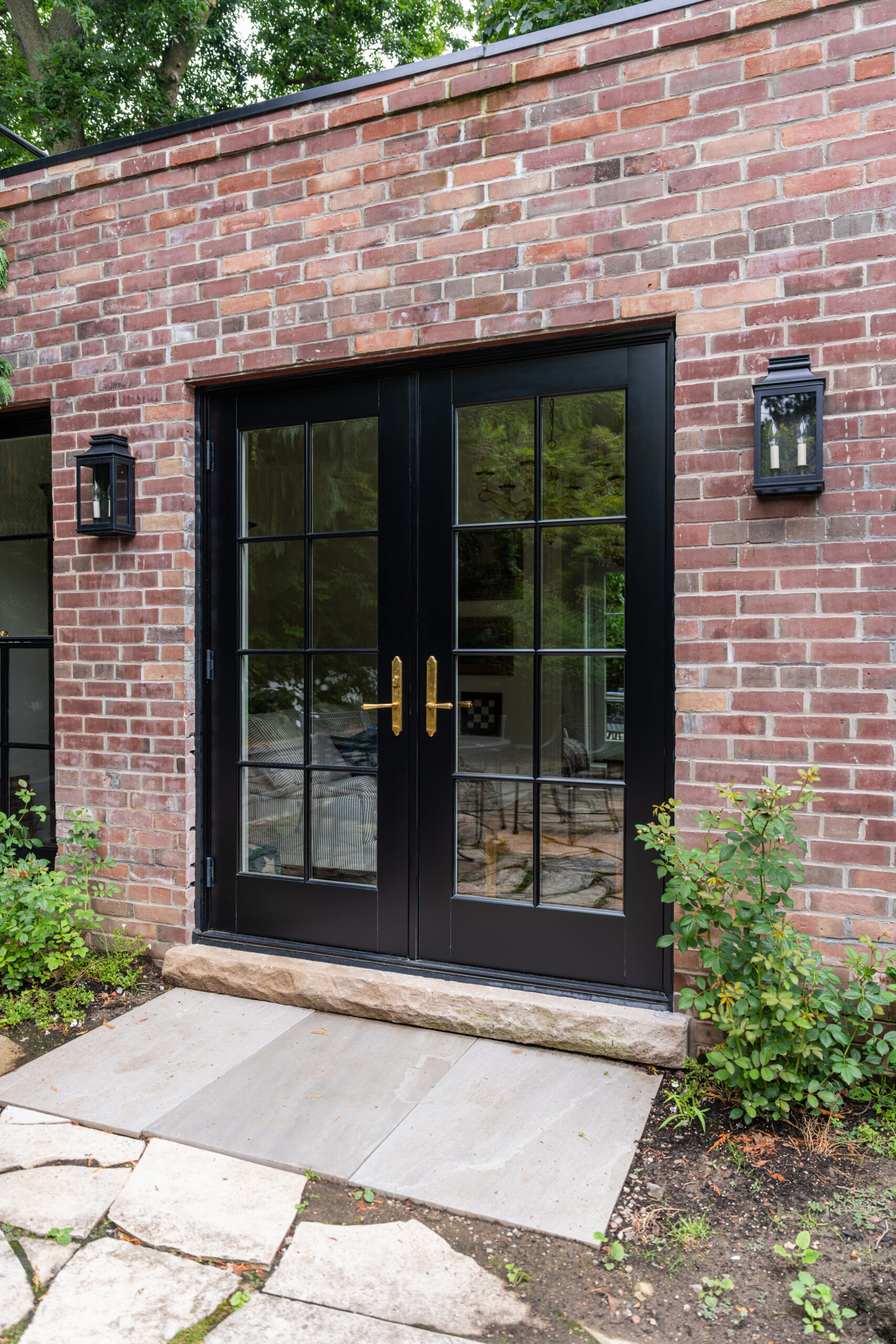 Side view of Red Grandis French doors on Toronto garden studio.