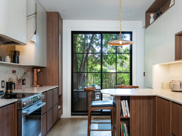 Black sliding door with grilles in Toronto kitchen